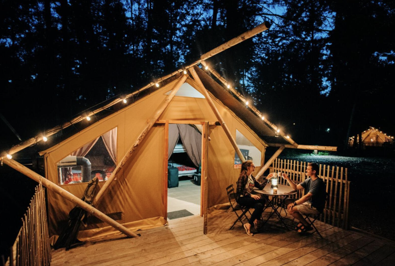 glamping tent lit up at night